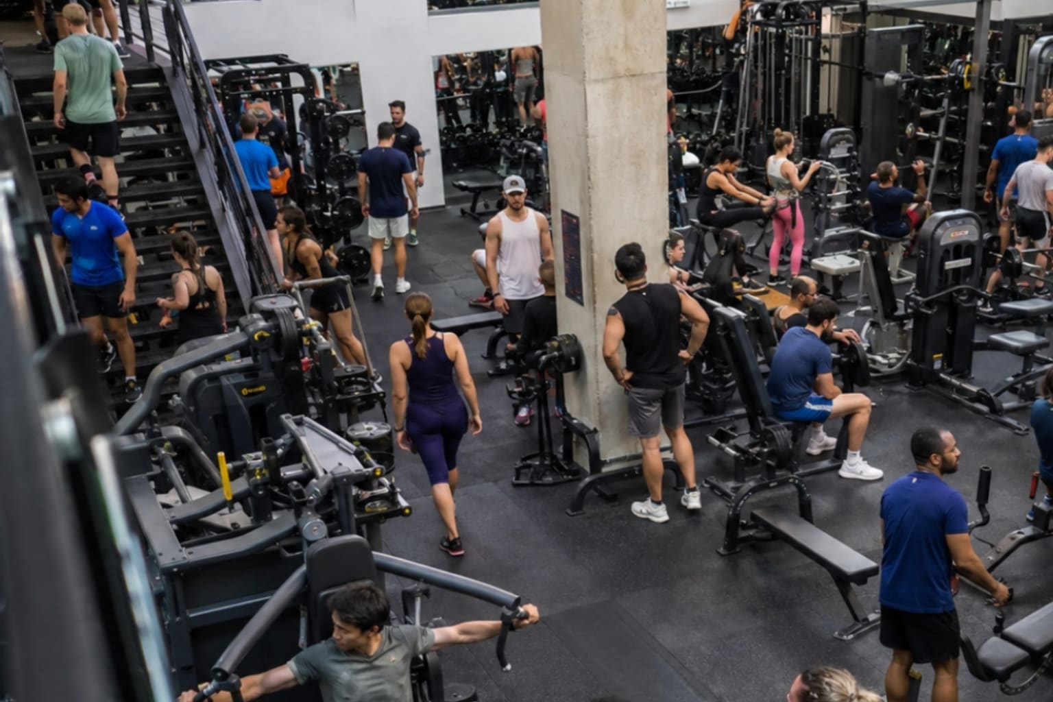 People training on a busy shared gym floor.